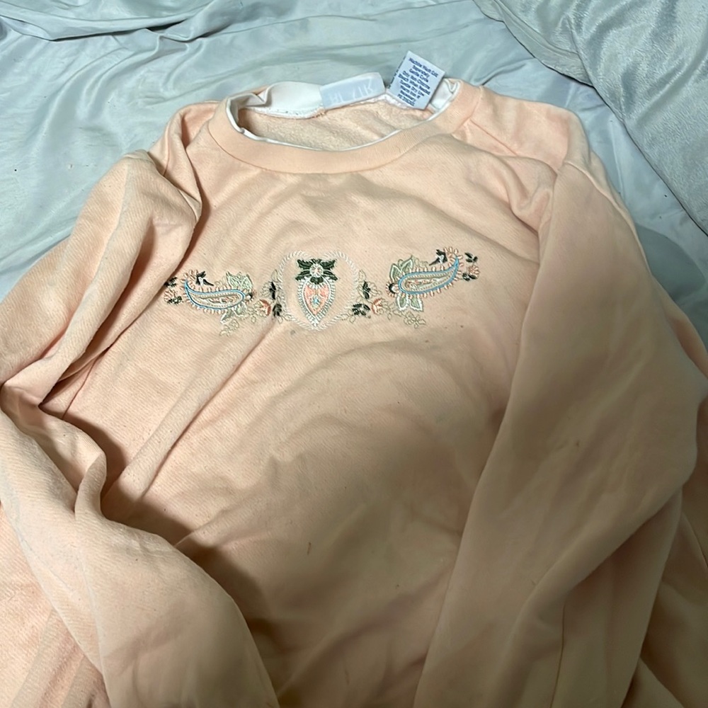 It’s a peach sweater vintage but in good condition